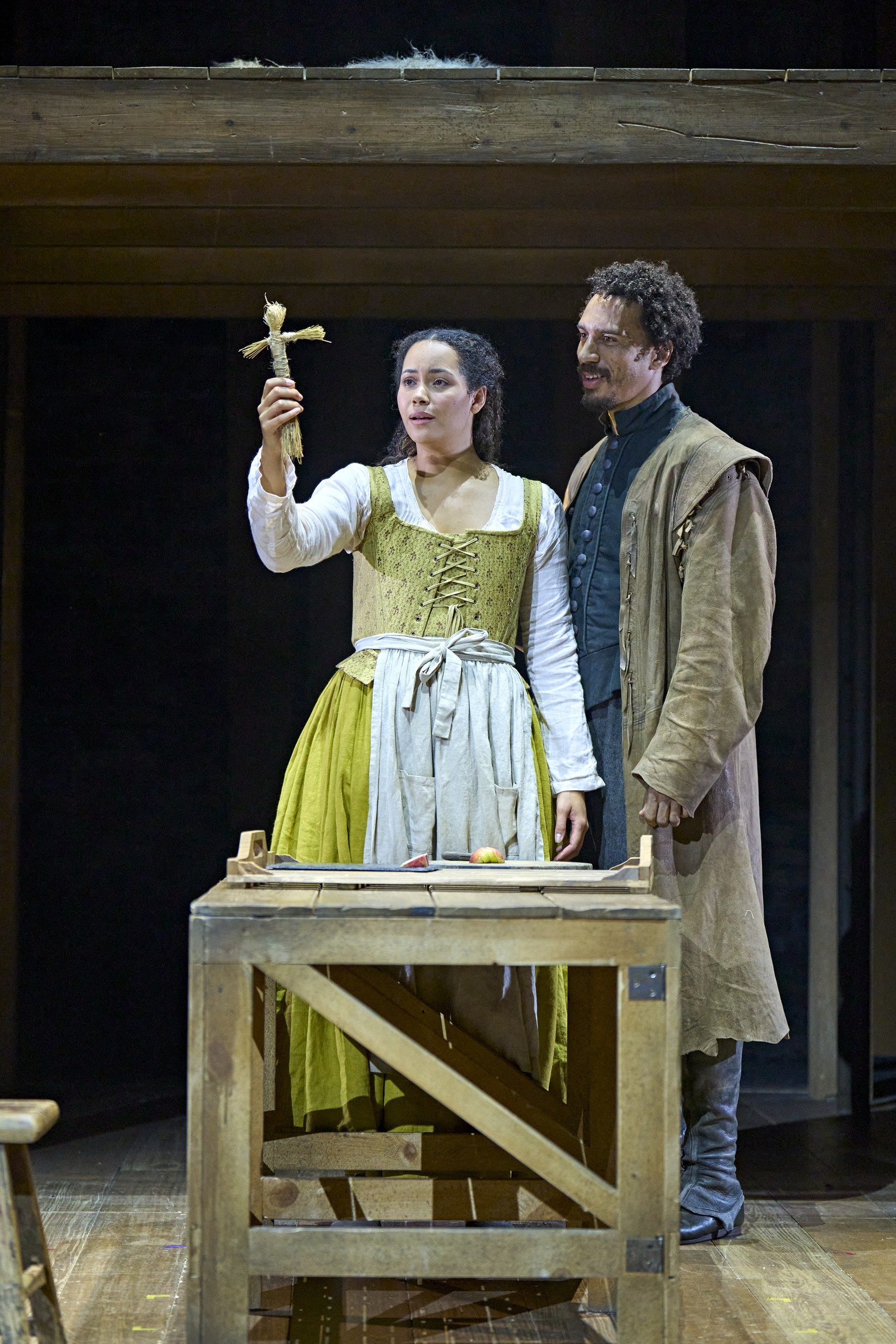 London cast members of Hamnet pose together on stage, dressed in period costumes, with dramatic lighting.