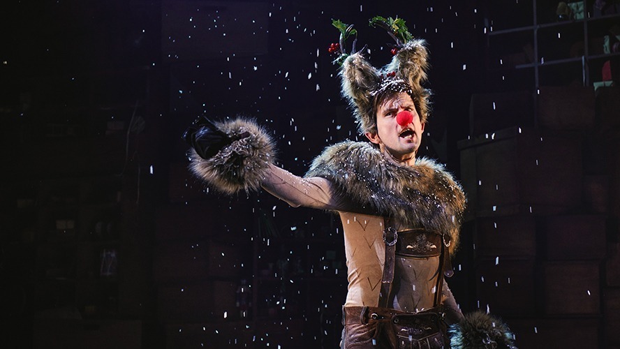 Matt Crockett performing in a festive scene from A Christmas Carol (ish), wearing a Victorian-style costume.
