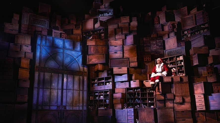 Matt Crockett performing in a scene from "A Christmas Carol (ish)" on stage.