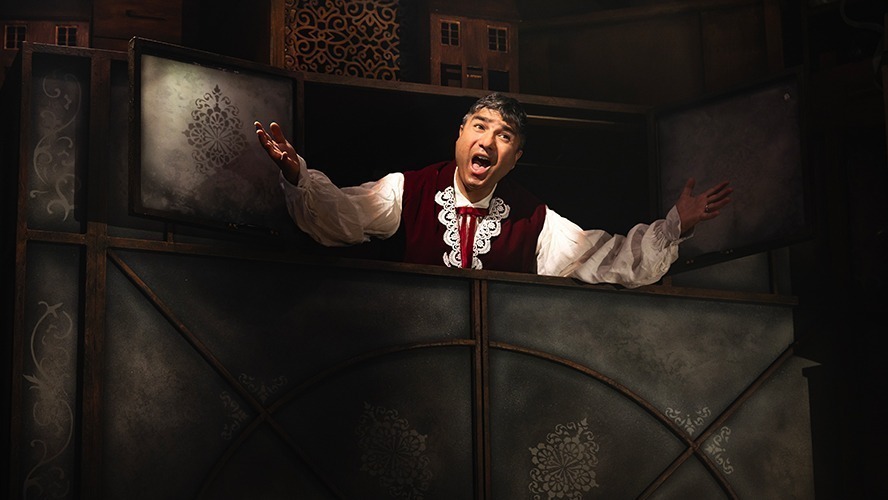 Matt Crockett performing in a scene from "A Christmas Carol (ish)" on stage.