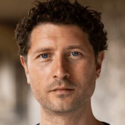 Cary Crankson, a man with short hair, wearing a black shirt, against a neutral background.