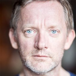 Douglas Henshall performing on stage in a dramatic scene from White Rabbit Red Rabbit.