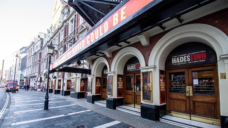 Exterior view of the Lyric Theatre, featuring ornate architecture and a marquee with bright lights.