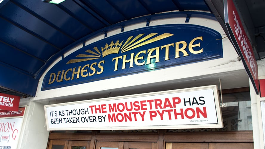 Exterior view of the Duchess Theatre, showcasing its ornate architecture and illuminated marquee.