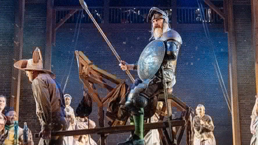 A scene from Don Quixote featuring a knight in armour, holding a lance, on horseback.