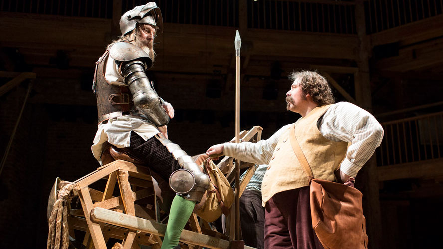 A scene from Don Quixote featuring a knight in armour on horseback, with dramatic lighting.