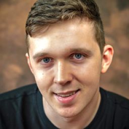 Ed Larkin, a middle-aged man with short brown hair, wearing a navy blazer and white shirt.