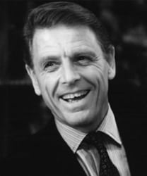 Edward Fox, a middle-aged man with short grey hair, wearing a dark suit and tie.