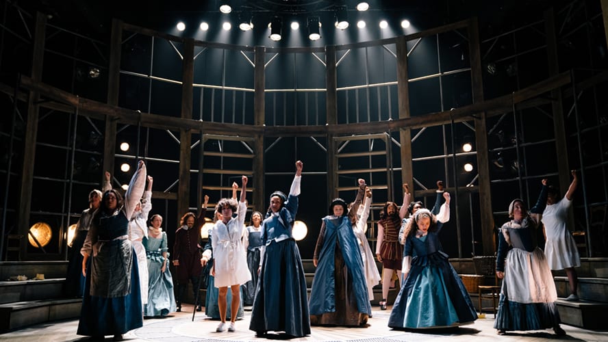 A theatrical scene featuring actors performing on stage at the Vaudeville Theatre, with dramatic lighting.