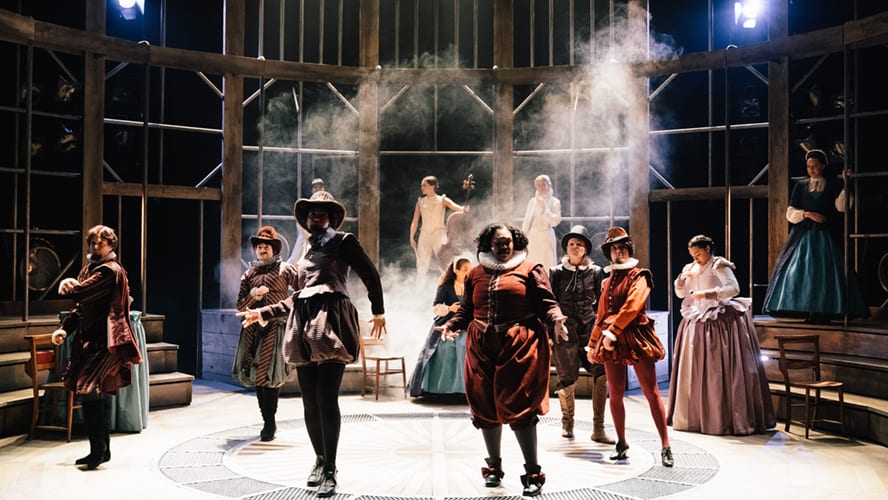 Actors performing on stage at Vaudeville Theatre, with vibrant costumes and dramatic lighting.