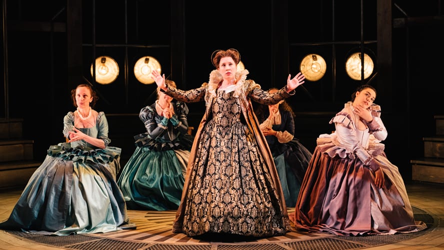 A theatrical scene from "Emilia" at Vaudeville Theatre, featuring actors in period costumes on stage.