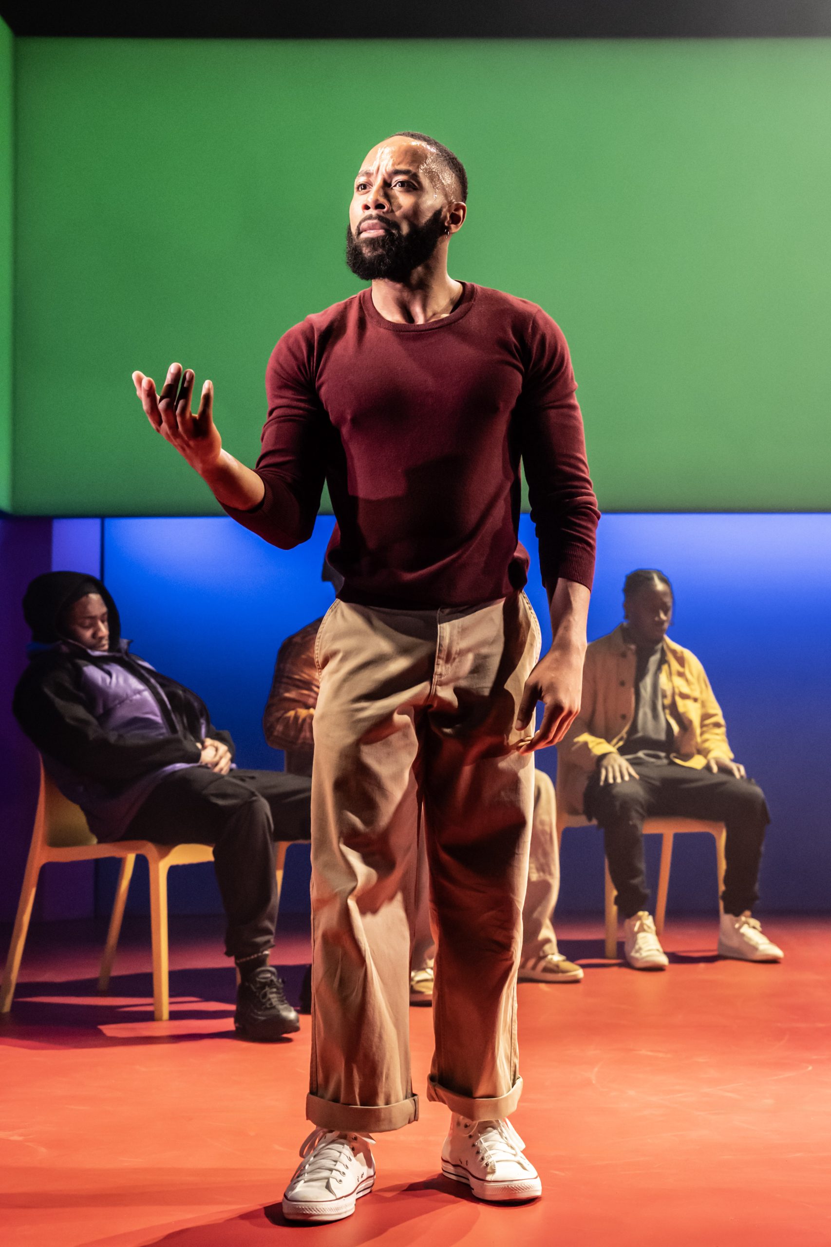 A theatrical performance scene featuring actors on stage at the Apollo Theatre, London, 2024.