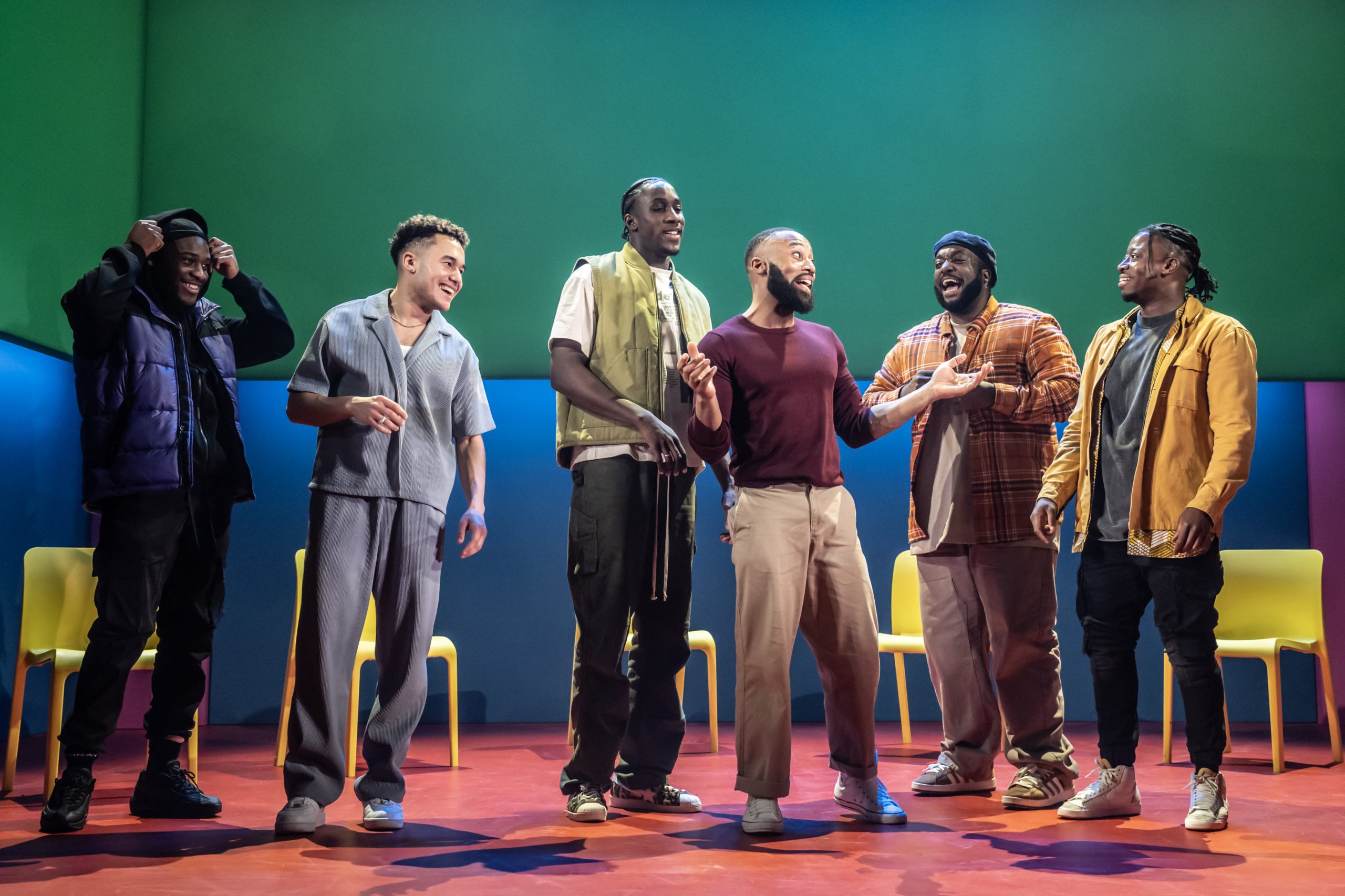 A stage scene from "For Black Boys Who Have Considered Suicide" featuring dramatic lighting and actors.