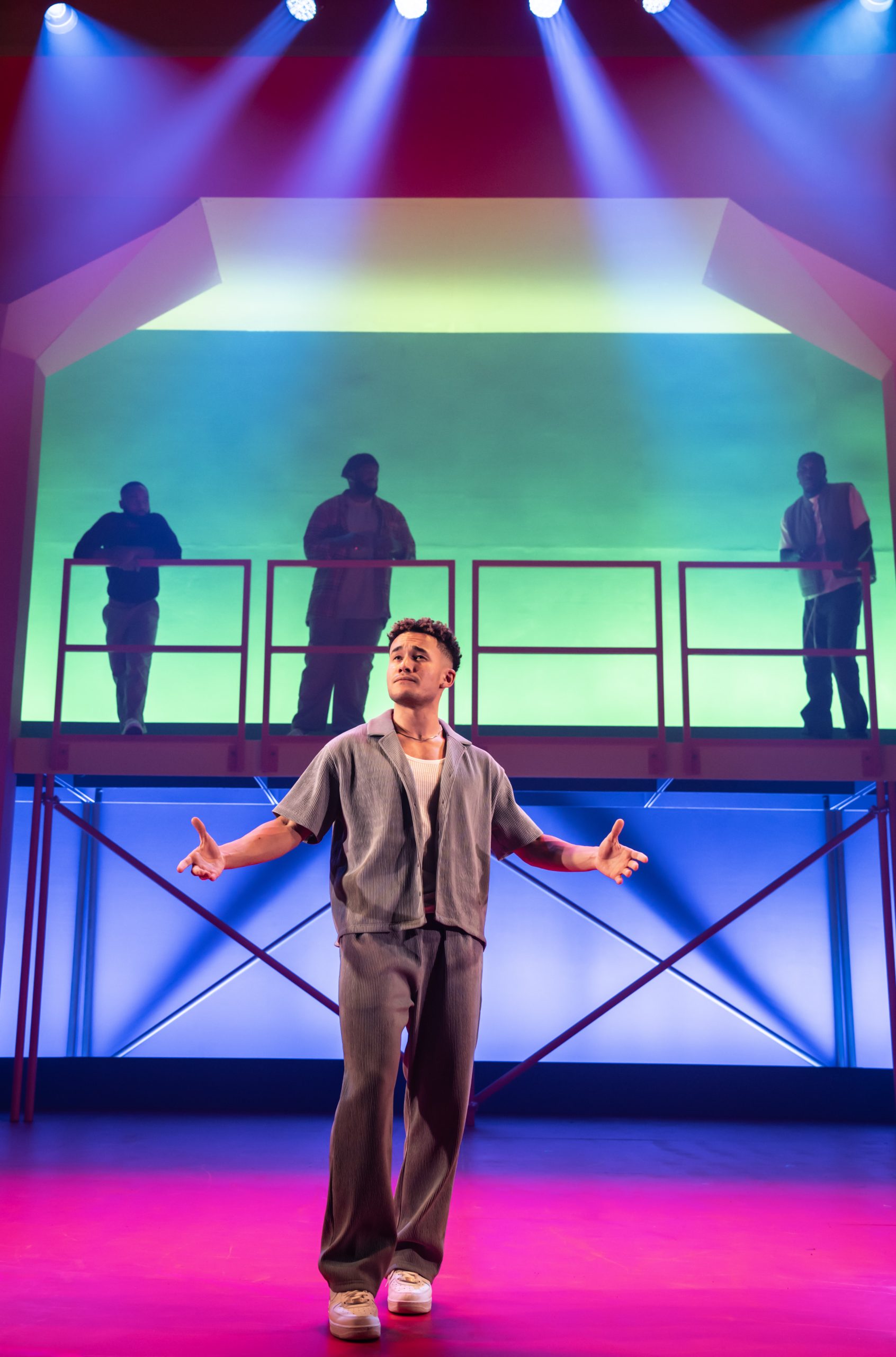 A stage scene from "For Black Boys Who Have Considered Suicide" featuring actors in dramatic lighting.