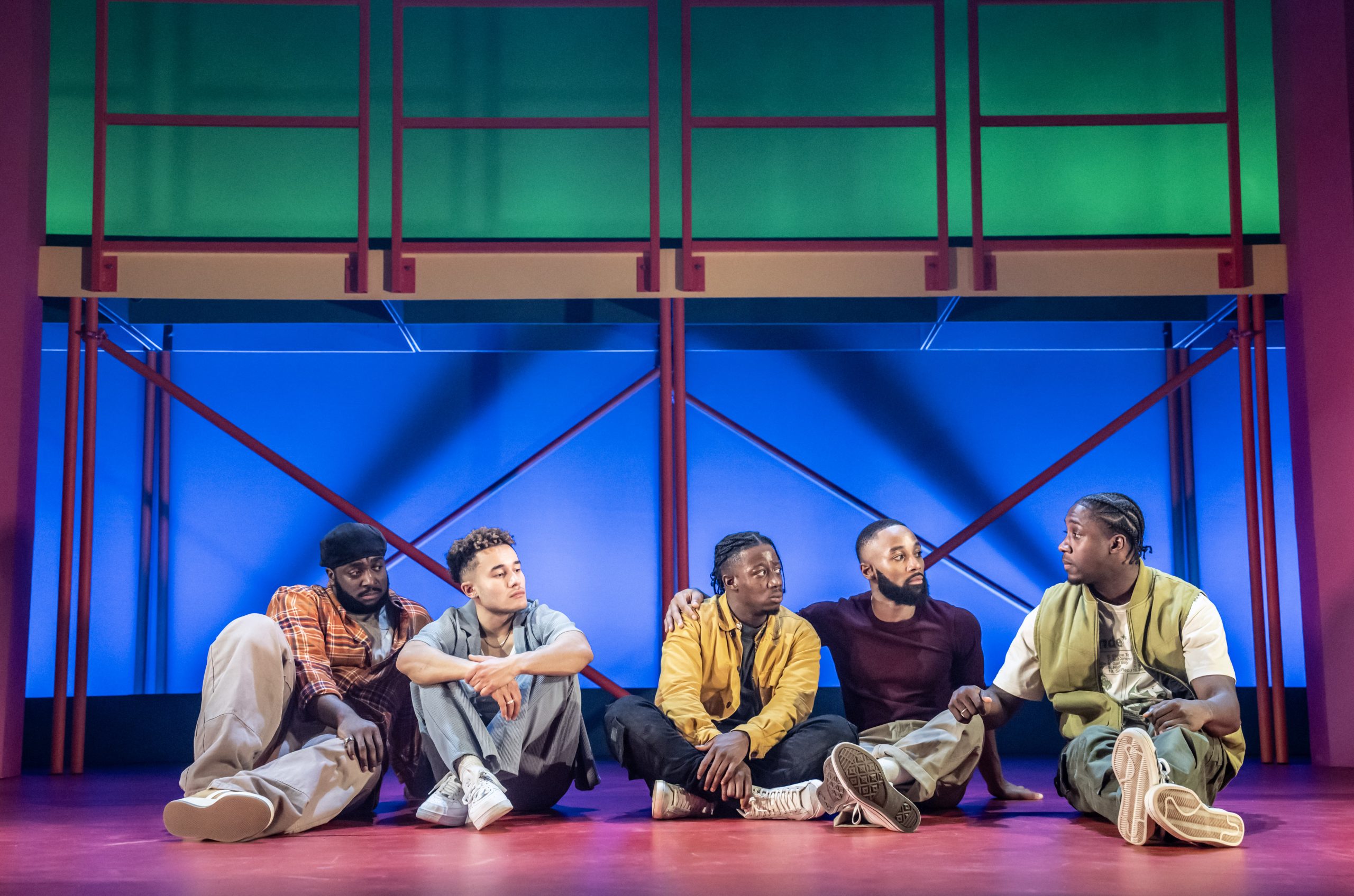 A stage scene from "For Black Boys Who Have Considered Suicide," featuring dramatic lighting and actors.