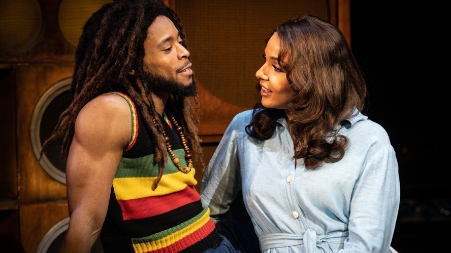 A vibrant stage set with colourful lighting and performers in dynamic poses at Lyric Theatre.