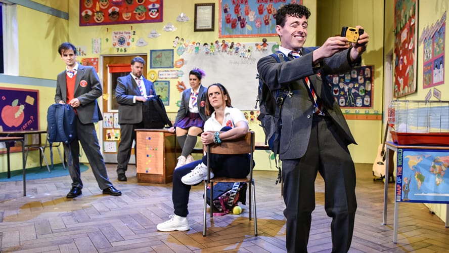 A lively stage performance at the Vaudeville Theatre, featuring actors in colourful costumes and dramatic lighting.