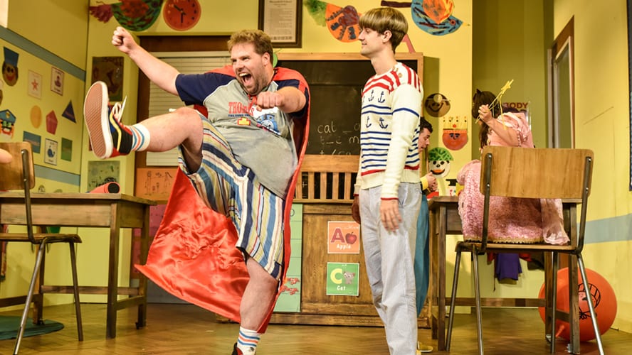 A lively vaudeville theatre stage with colourful curtains and performers in vintage costumes.