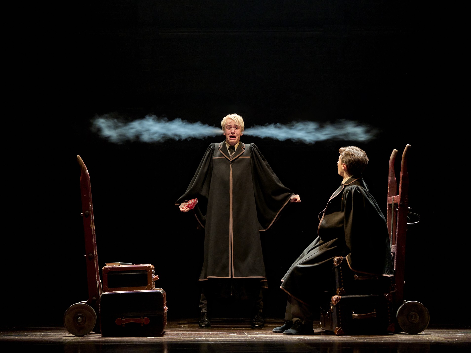 A scene from Harry Potter and the Cursed Child, featuring actors in elaborate costumes on stage.