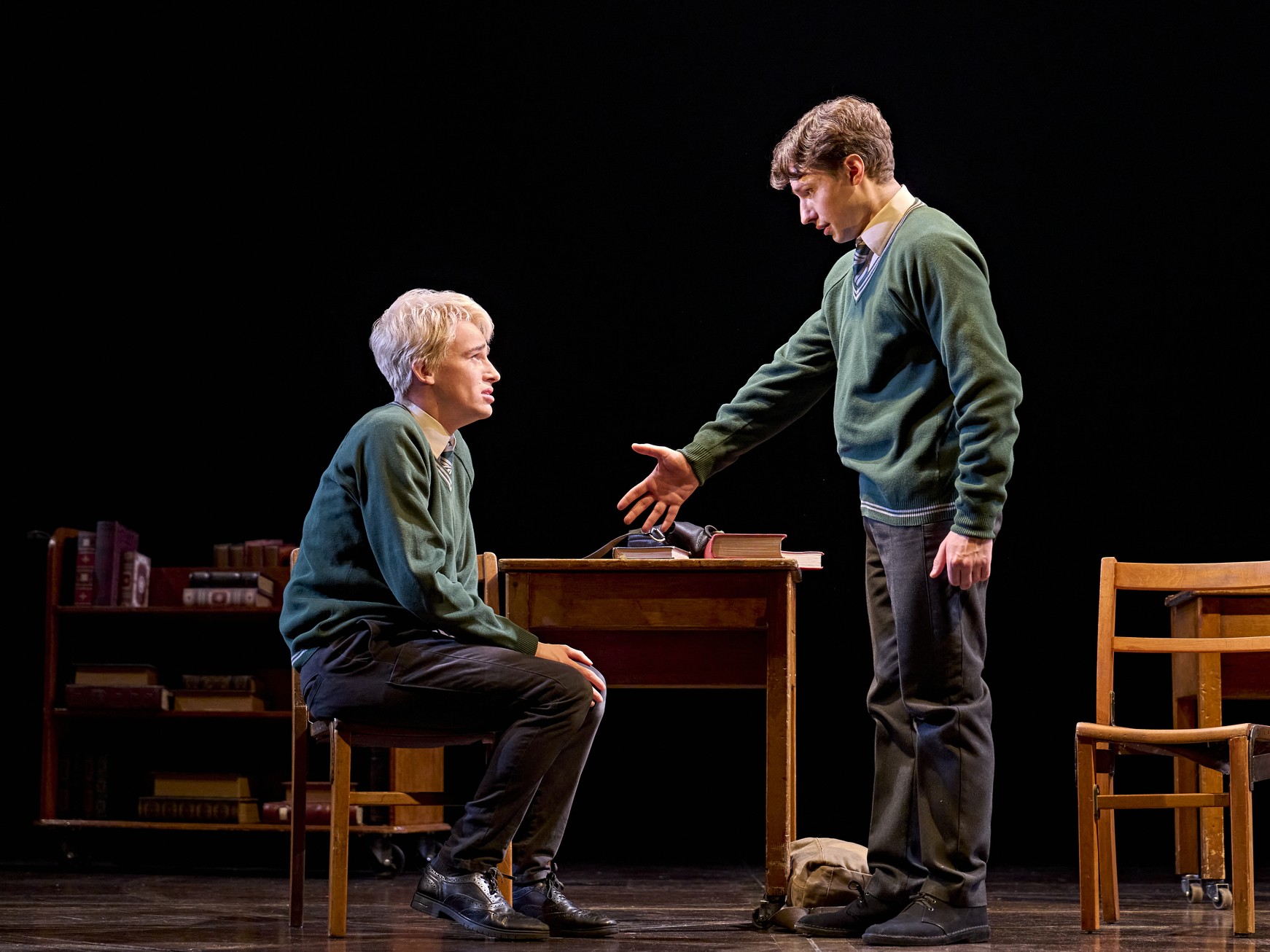 A scene from Harry Potter and the Cursed Child, featuring actors in elaborate costumes on stage.