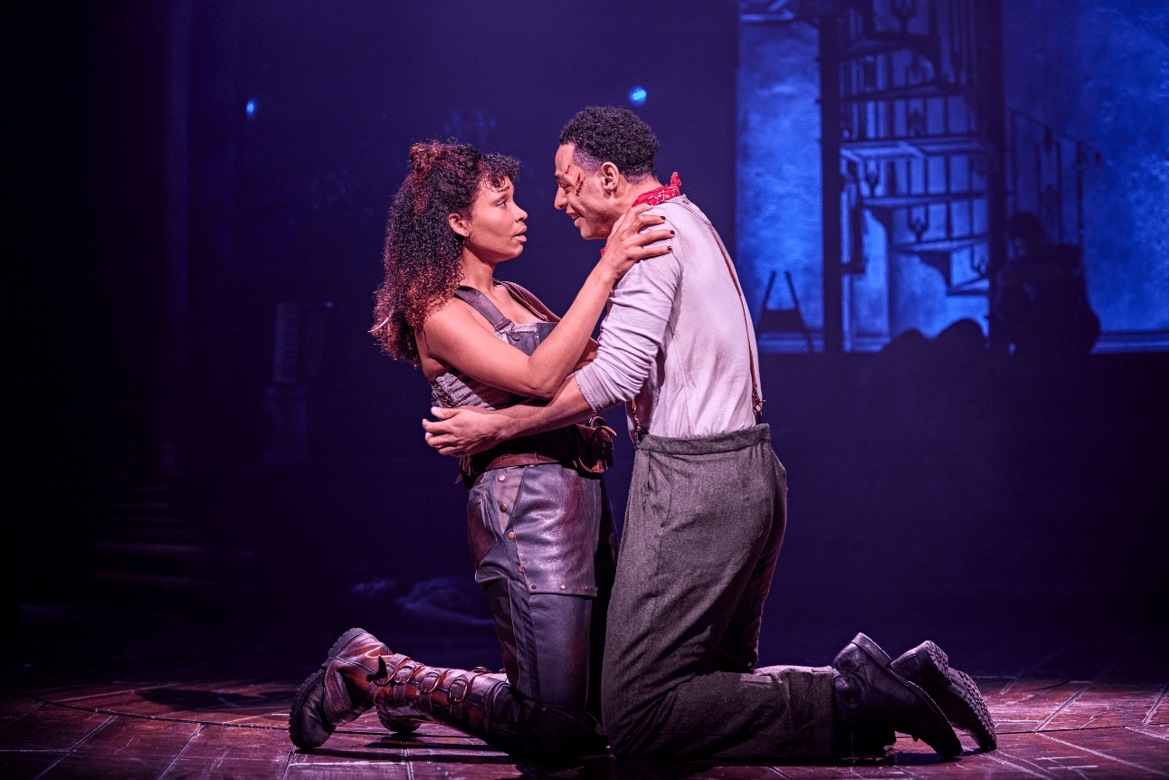 Eurydice and Orpheus hold each other closely and tenderly