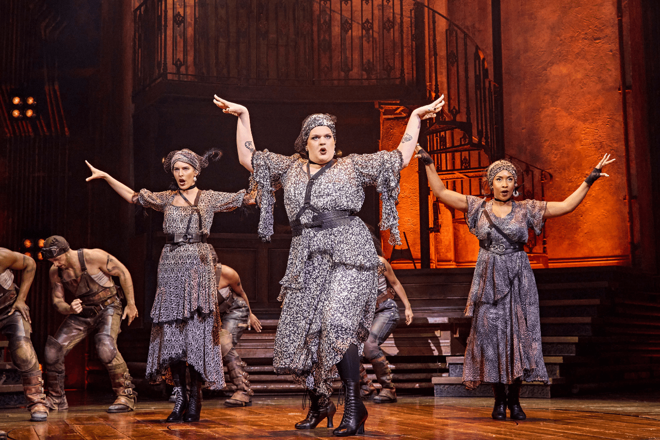The three Fates dance with their arms outstretched