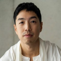 Portrait of Jeffrey Chekai against a backdrop of traditional Kyoto architecture and cherry blossoms.