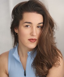 Laura Dawn Pyatt, a woman with long brown hair, smiling in a professional setting.