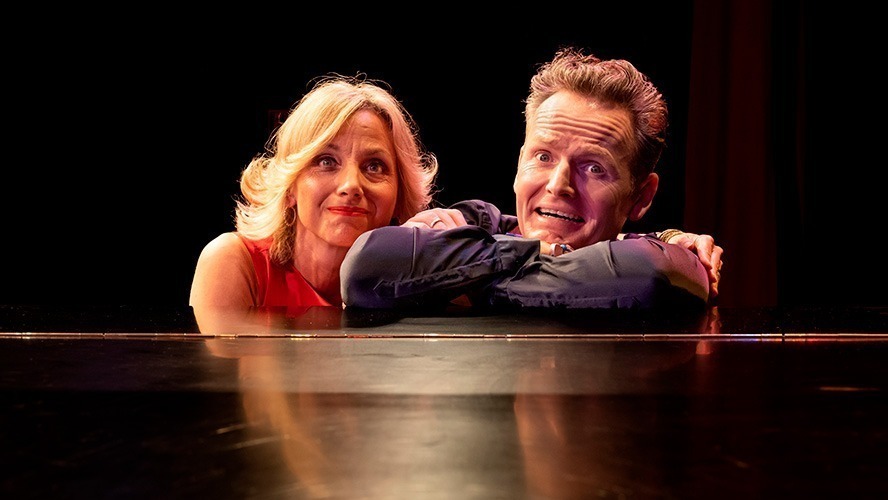 Liza Pulman and Jow Stilgoe smiling together at an event, dressed in formal attire.