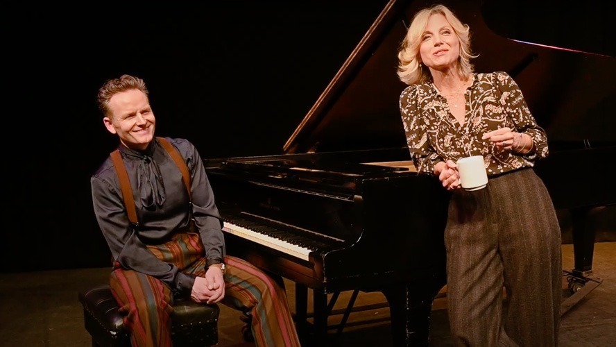 Liza Pulman and Jow Stilgoe smiling together at an event, dressed in smart casual attire.