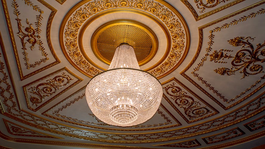 Elegant interior of Lyric Theatre featuring ornate architecture, plush seating, and warm lighting.