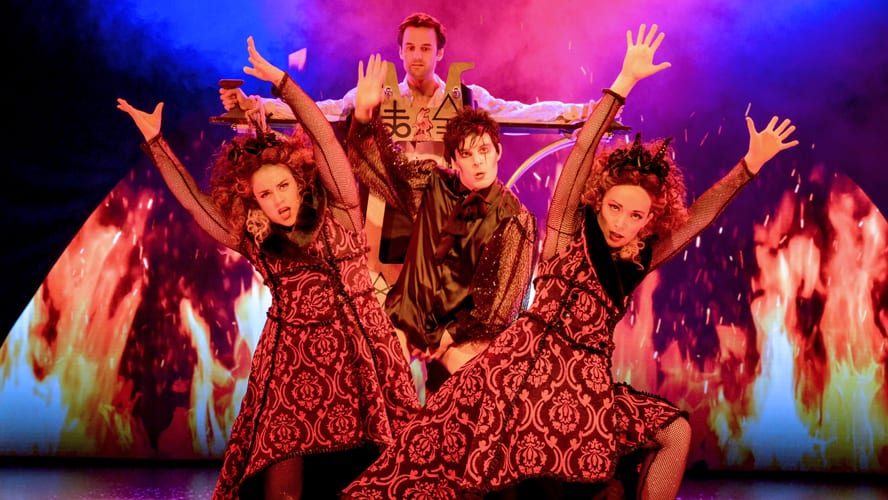 A stage at the Vaudeville Theatre, featuring elaborate props and dramatic lighting for a magic show.