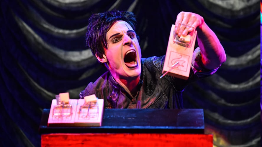 A stage at the Vaudeville Theatre with performers in vibrant costumes and dramatic lighting.