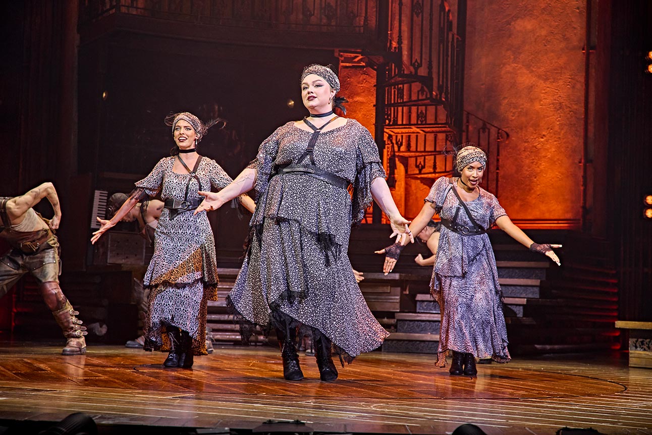 Melanie Bright, Allie Daniel, and Lauran Rae as the Fates, dressed in flowing, dark costumes.