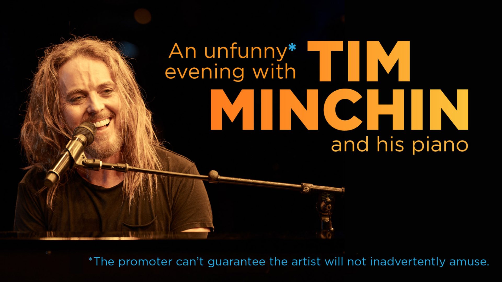 Tim Minchin performing on stage with a piano, spotlight illuminating him against a dark background.