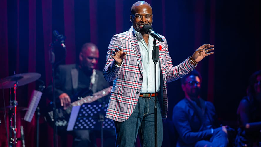 A lively performance at the Apollo Theatre, featuring a diverse audience enjoying the show.
