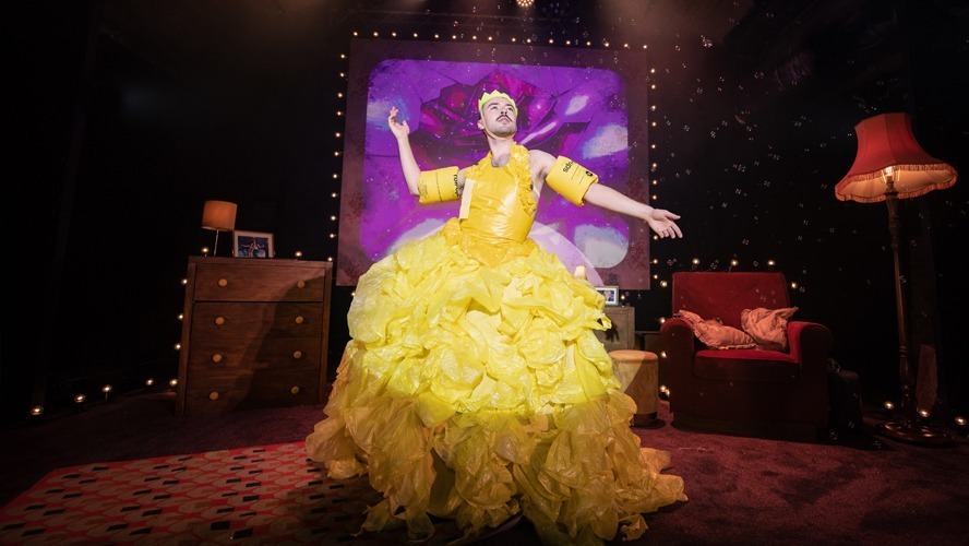 A vibrant stage with colourful lights, featuring performers in diverse costumes and expressive poses.