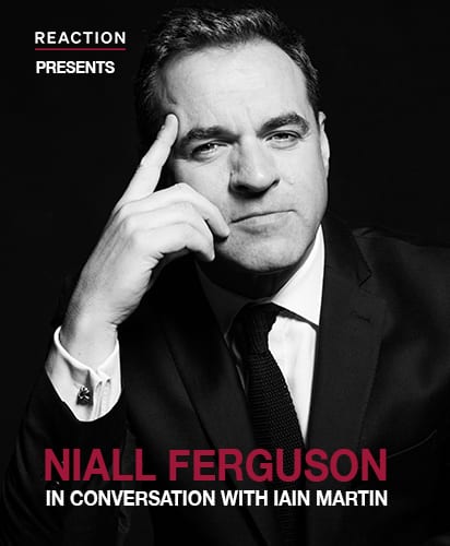 Niall Ferguson, a middle-aged man with dark hair, wearing glasses and a suit, smiles at the camera.