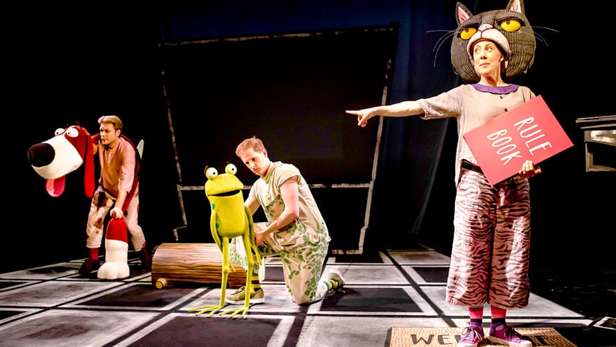 Colourful stage set featuring whimsical animal characters from "Oi Frog and Friends" in a playful scene.