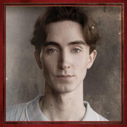 Young man with short brown hair, wearing a light shirt, neutral expression, textured brown background.