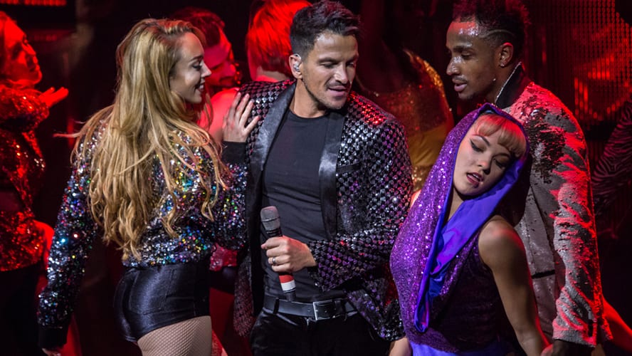 Peter Andre performing energetically on stage during Thriller Live at the Lyric Theatre.
