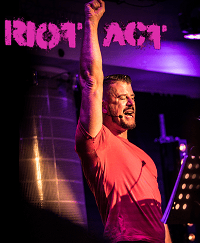 RIOT ACT logo displayed prominently on a white background with bold typography.