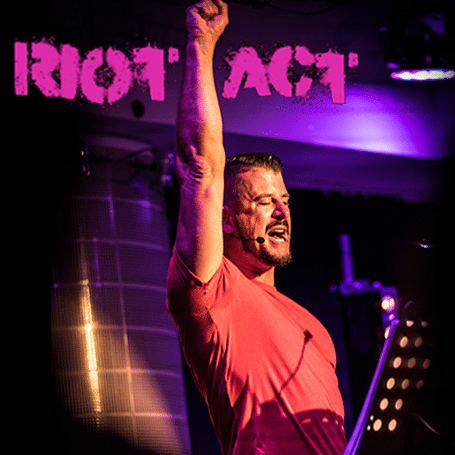 RIOT ACT logo displayed prominently on a square background, featuring bold typography and vibrant colours.