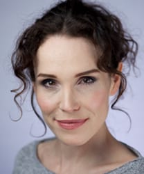 Rachel Heaton, a woman with shoulder-length brown hair, smiling against a neutral background.