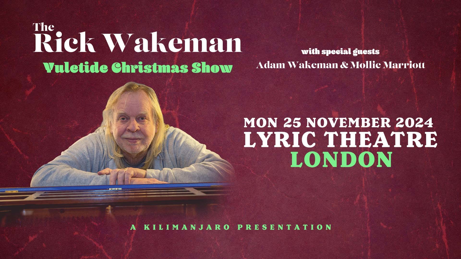 Rick Wakeman performing on stage, surrounded by musical instruments and festive decorations during a Christmas show.