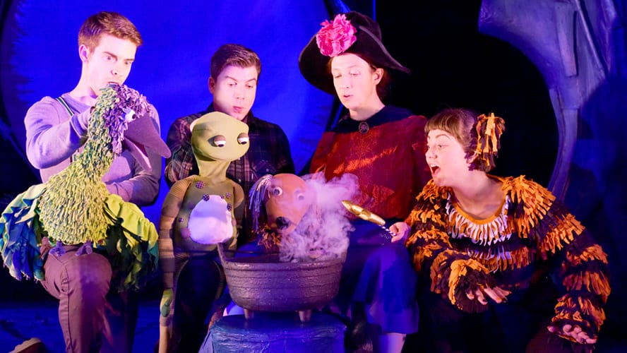 A whimsical scene featuring a witch, a cat, and various animals on a broomstick.