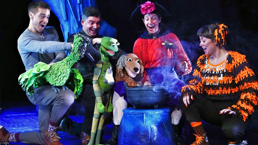 A whimsical scene featuring a witch and her animal companions flying on a broomstick.