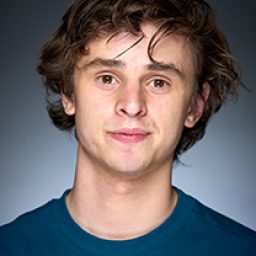 Sam Varley in costume, standing on stage with dramatic lighting, portraying a character from Harry Potter and the Cursed Child.