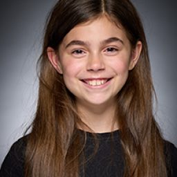 Sienna Sibley as a character from Harry Potter and the Cursed Child, smiling in costume.
