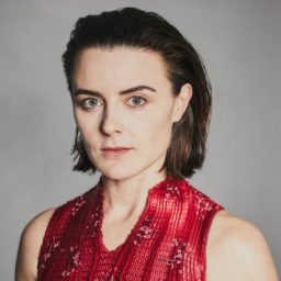 Sophie Reid with a neutral expression, framed closely, against a soft-focus background.